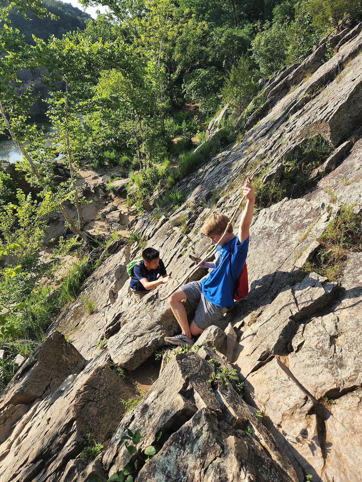 Hikers scrambling over boulders on the Billy Goat Trail in Maryland