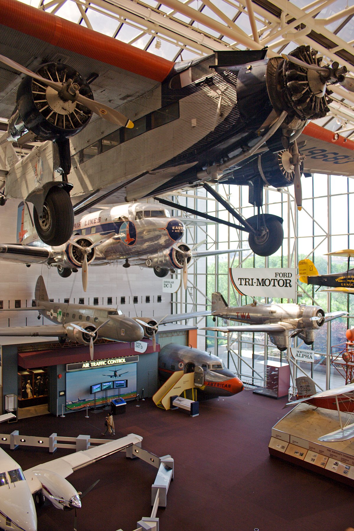 Historic aircraft suspended above visitors inside the National Air and Space Museum