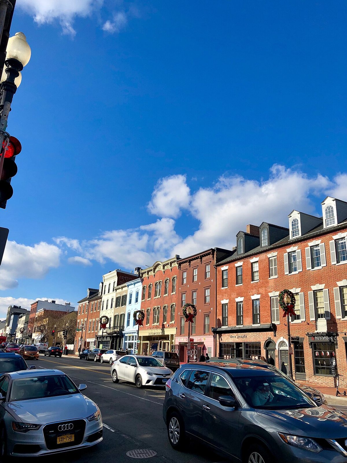 shoppers and historic rowhouse storefronts along M Street NW in Georgetown