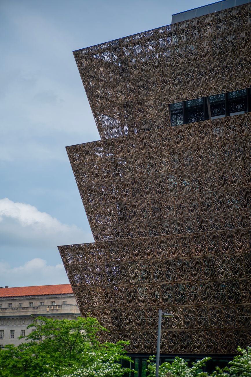 The bronze lattice exterior of the National Museum of African American History and Culture on the National Mall